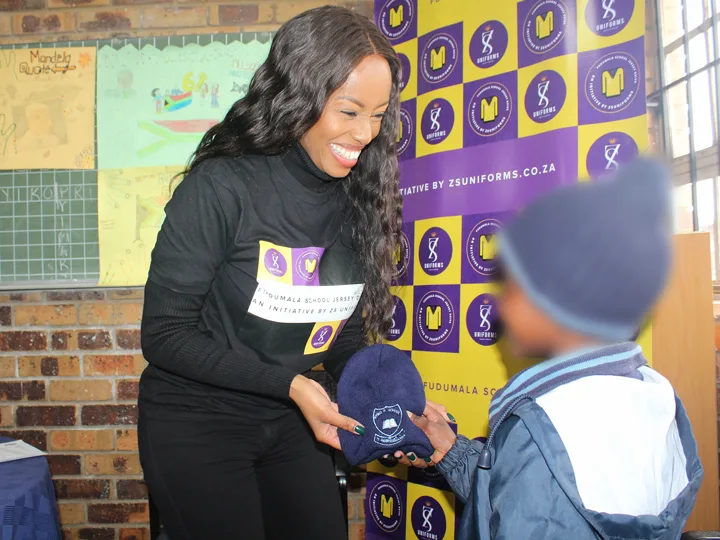 Volunteers distributing jerseys at school