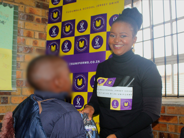 Learner receiving jersey at school handover event