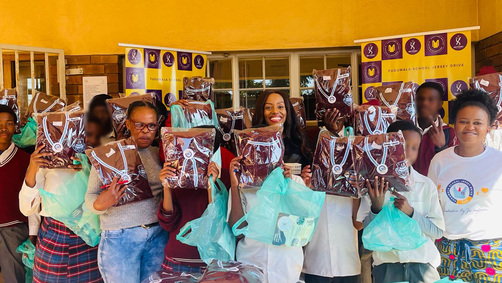 Learners holding sponsored school jerseys