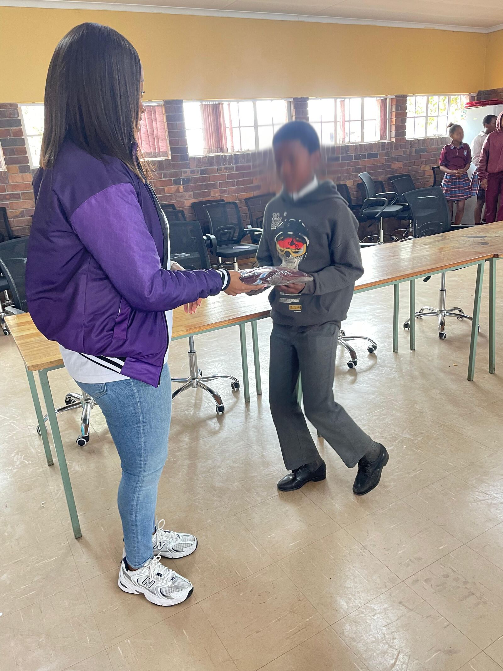 A Masisebenze Comprehensive School learner receiving his new school jersey, 27 August 2026
