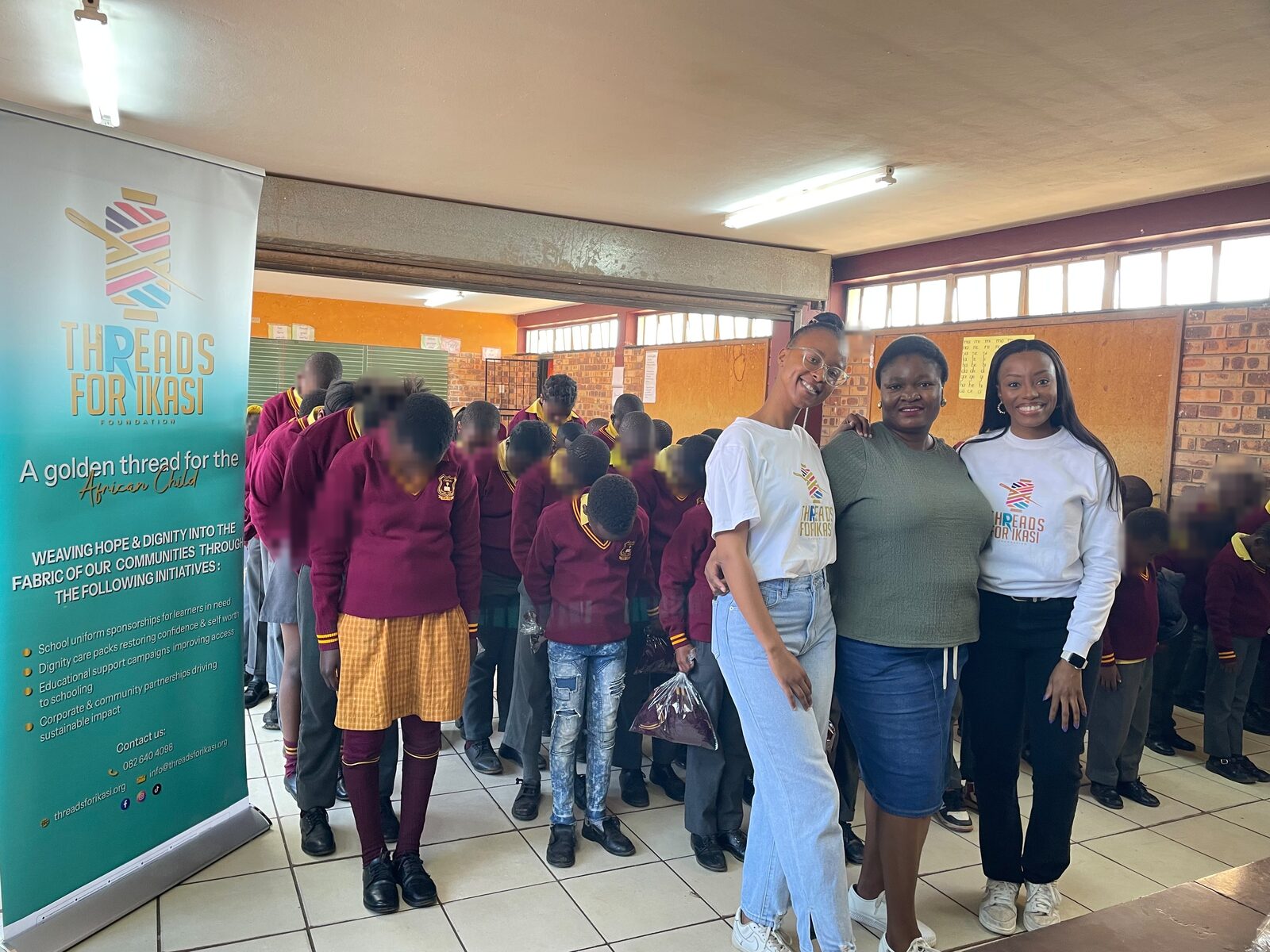 Threads for iKasi Foundation representatives standing alongside the line of Thuthuka Primary School learners waiting to receive their jerseys, 30 July 2026