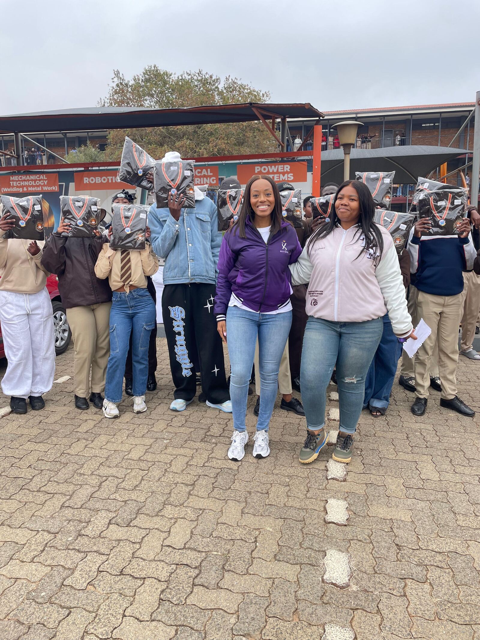 Thuto ke Maatla Engineering School of Specialization learners with their new jerseys in front of the school's engineering workshop banners, Tembisa, 27 August 2026