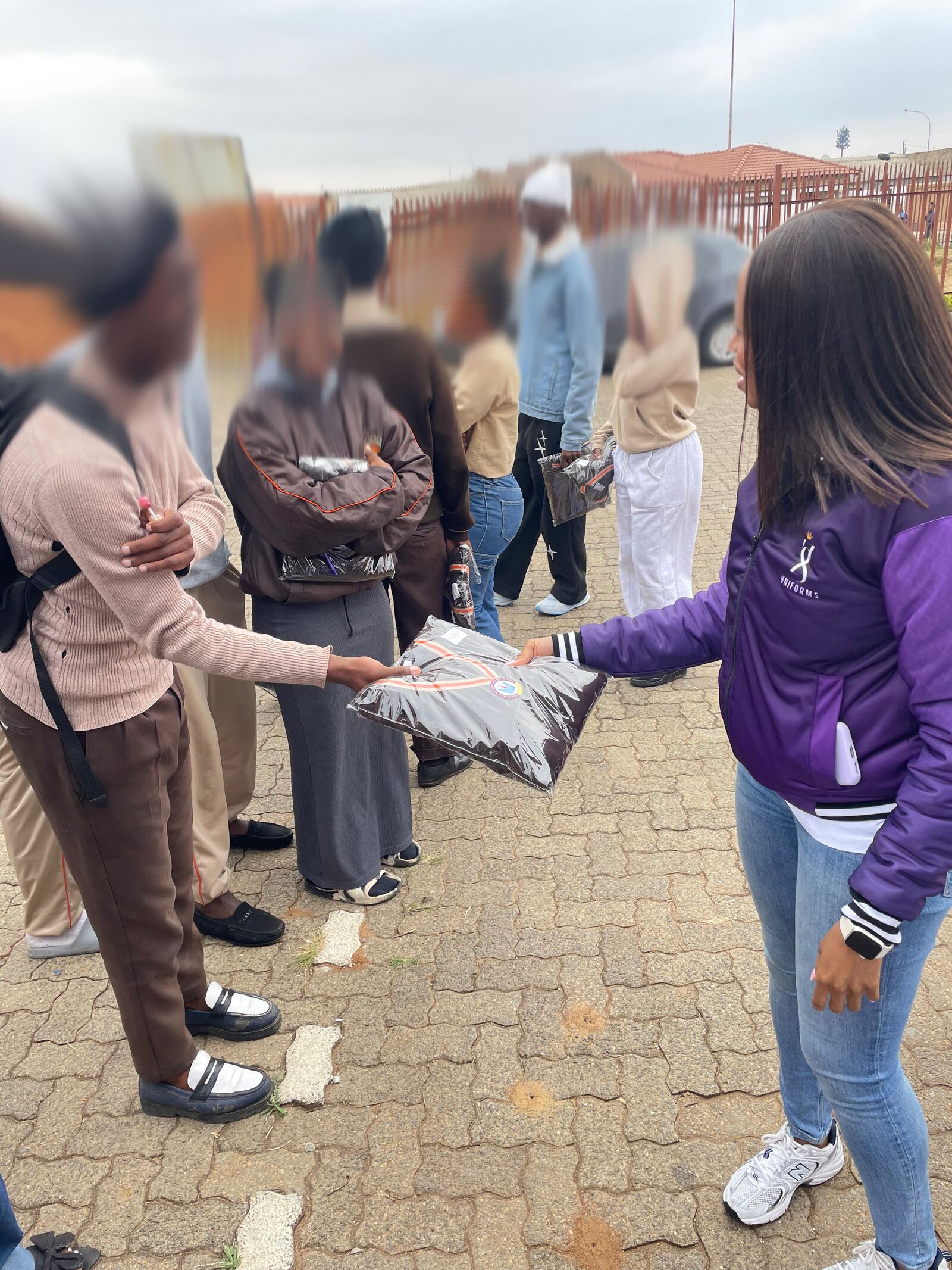 Thuto ke Maatla Engineering School of Specialization learners receiving their new school jerseys from a Threads for iKasi Foundation representative, 27 August 2026